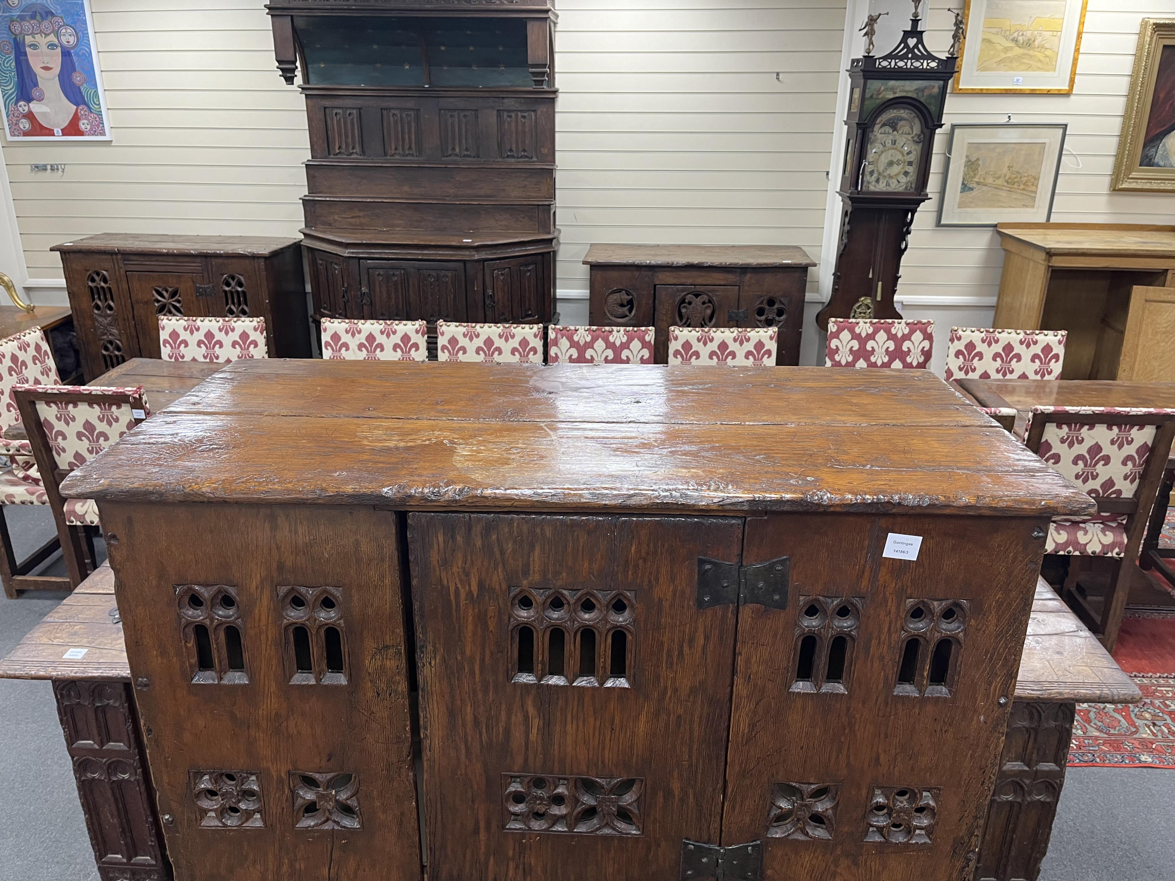 A large Gothic oak aumbry, in late 15th century style, with pierced fretwork panels, width 118cm, depth 53cm, height 151cm. Condition - good, Provenance - made for Brede Place, Brede, Rye, East Sussex. Commissioned from